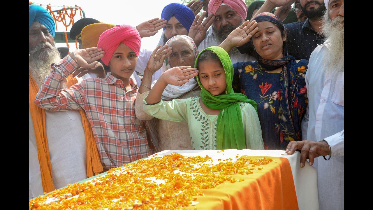 Family members pay their tribute to Naib Subedar Jaswinder Singh, who was among five army personnel killed during a militant attack in Poonch, during his funeral ceremony in Kapurthala district. Pic/PTI